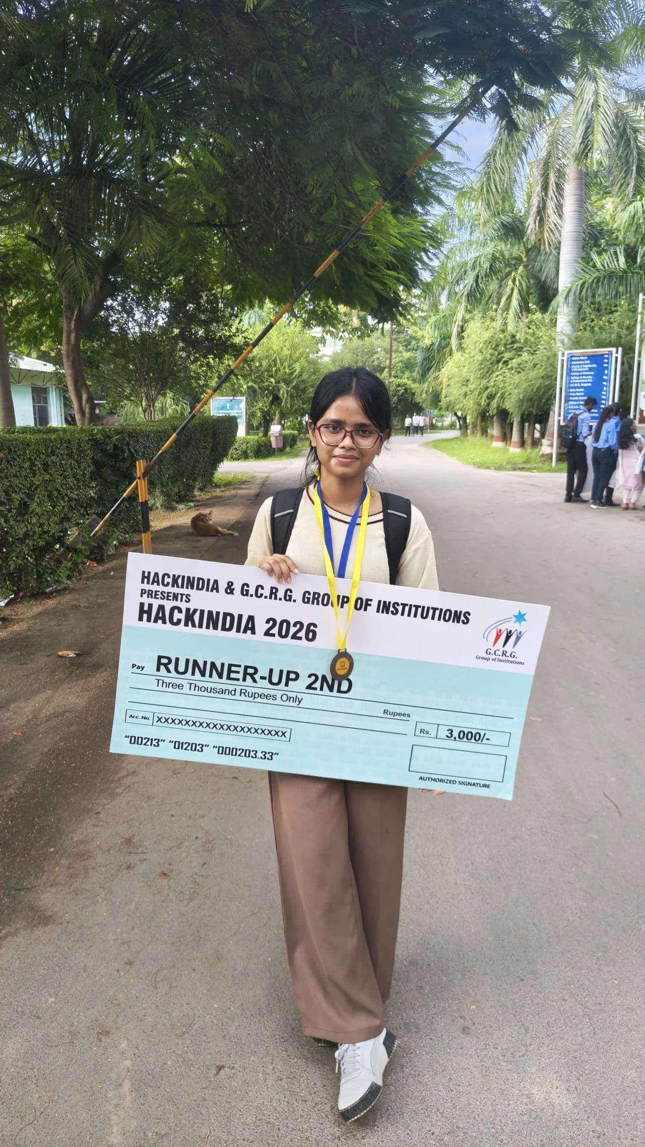 HackIndia 2026 participant holding a second runner-up prize cheque at G.C.R.G. Group of Institutions