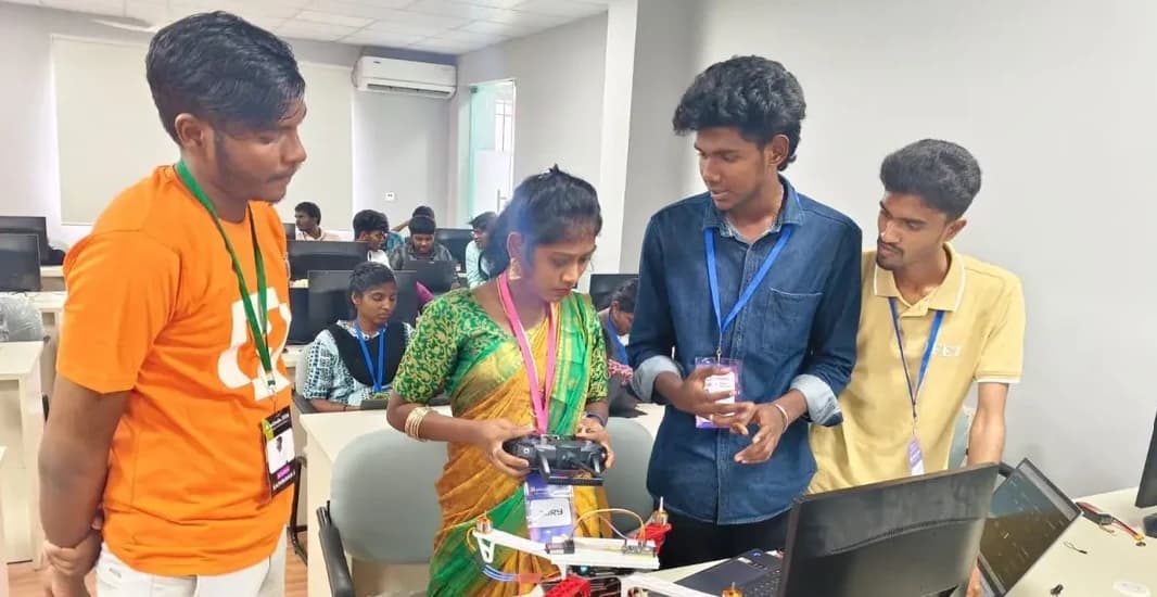 Sangeetha Vengatesan judging a team's drone project at HackIndia