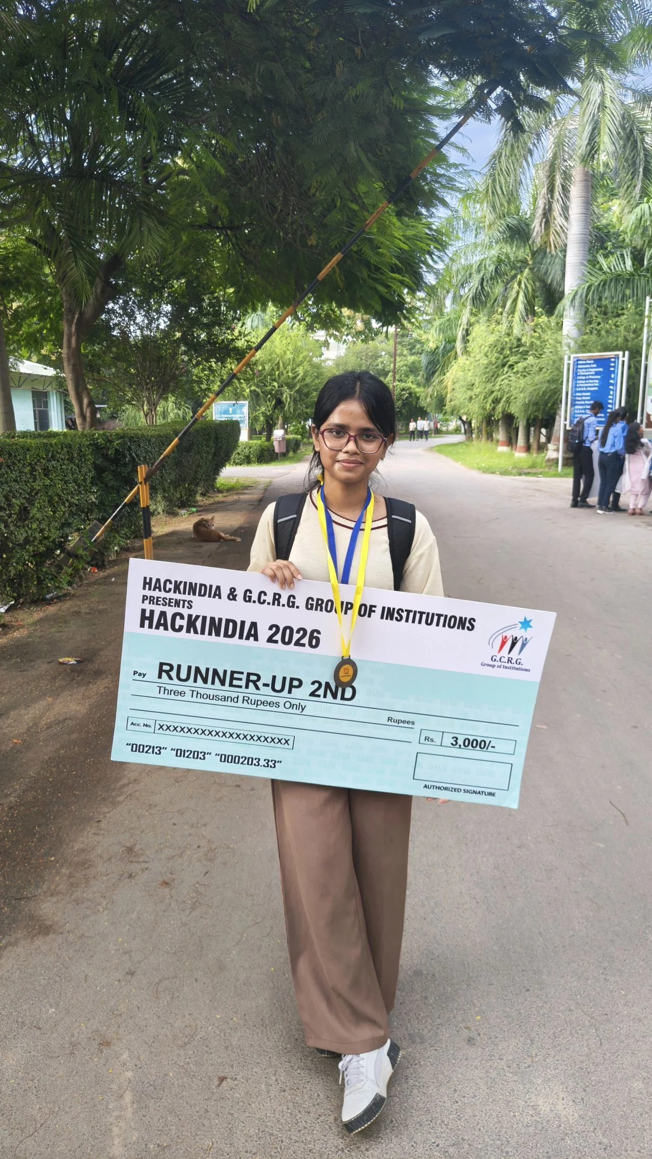 HackIndia 2026 participant holding a second runner-up prize cheque at G.C.R.G. Group of Institutions